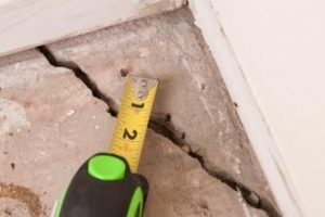 tape measure over foundation crack